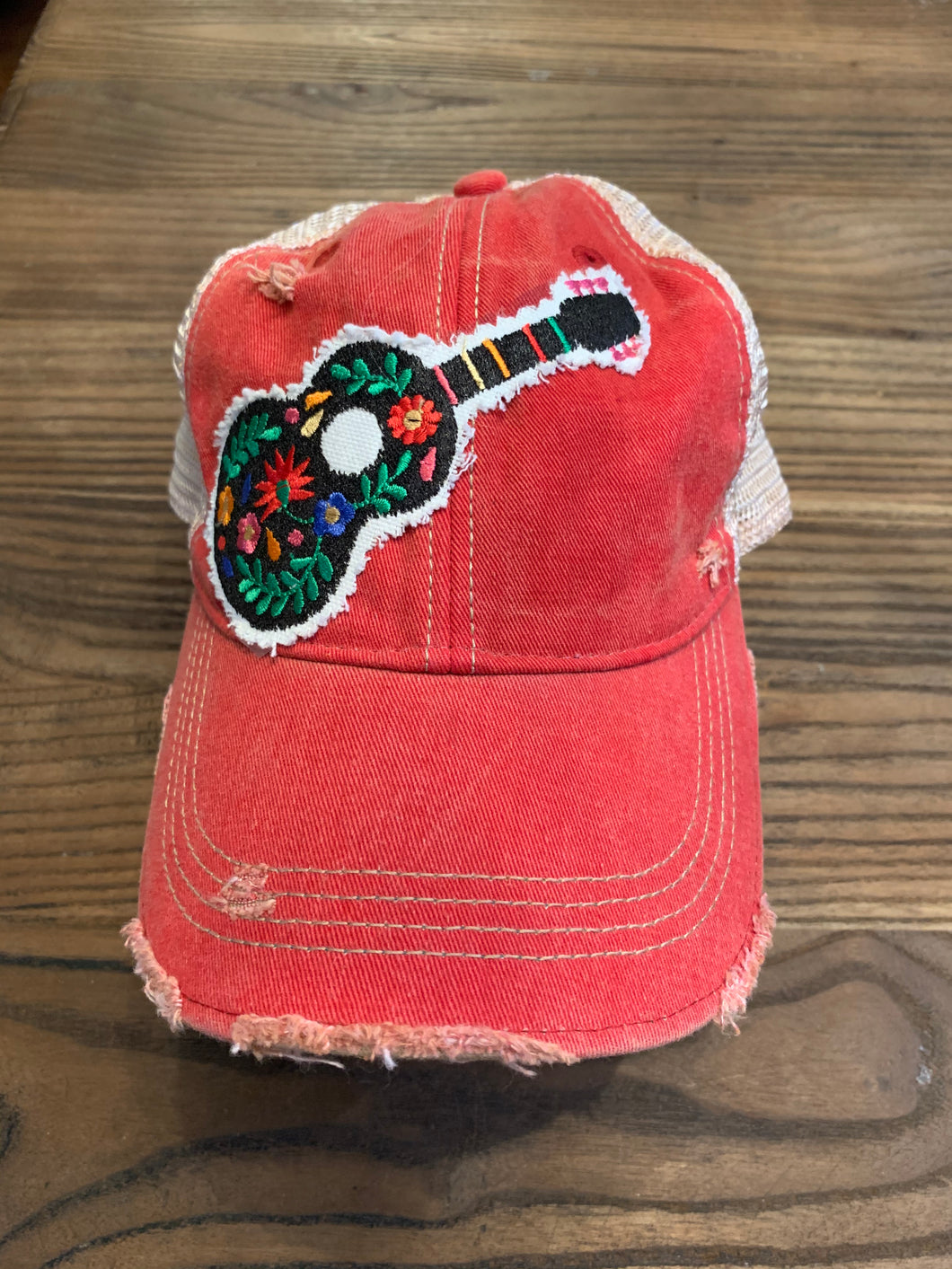 Floral guitar on vintage red hat